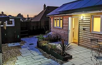 Outside view of Totland Bay Cabin at night-time, self-catering, Isle of Wight