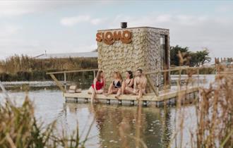 Group of people enjoying the floating sauna at Tapnell Farm, Isle of Wight, wellbeing event, wellness retreat, what's on, event