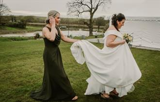 Isle of Wight, Wedding Venue, Westover Farm, Calbourne, Bride and Bridesmaid walking in front of lake