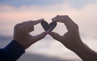 Couple holding a shell in the shape of a heart, The Seaview Hotel Valentines package, Isle of Wight