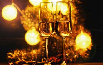 Prosecco with two glasses and lights in the background, New Year's Eve party at The Seaview Hotel, party, 2026 celebration, what's on, event, Isle of