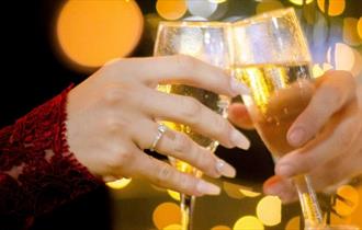 Two people celebrating with prosecco glasses, New Year's Eve party at The Portland Inn, Gurnard, Isle of Wight