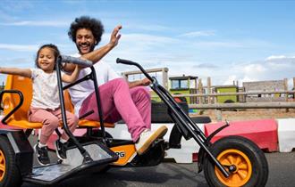 Father and daughter on the go karts at Tapnell Farm Park, Isle of Wight, attraction, family fun, activities