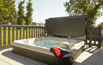 Hot tub on balcony of lodge at St Helens Holiday Resort, Isle of Wight, Self Catering