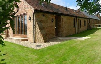 Outside view of Lacewood barn surrounded by garden, Fernhill Barns, Wootton, Isle of Wight, self-catering