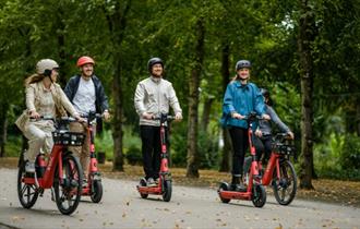 Group of people hiring electric bikes and electric scooters from Voi, getting around, Isle of Wight, bike hire, cycling