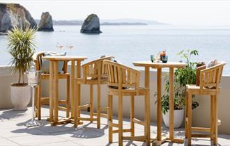 Tables and chairs on terrace with sea views at The Albion Hotel, Freshwater, boutique hotel, luxury, Isle of Wight