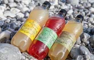 Selection of soft drinks produced by Wight Crystal laid on the beach, Isle of Wight, local produce, let's buy local