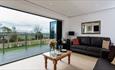 Living area with bi-fold doors leading to the decking with views of the countryside at Fastnet, Fair Isle Holiday Cottages, self catering, Newport, Is