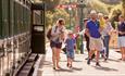 Family stepping off the steam train onto the platform, Isle of Wight Steam Railway, Things to Do, Isle of Wight