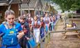 Group of children walking from the creek at PGL Little Canada at Wotton, Isle of Wight, kids' adventure camp