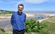 Photo of Dr Ben Robinson with the sea in the background, Isle of Wight Literary Festival, what's on, event