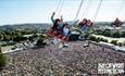 People on the swing ride in the air at the Isle of Wight Festival, music, events, what's on