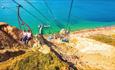 People on chairlift with beach and the sea in the background, The Needles Landmark Attraction, Isle of Wight, Things to Do