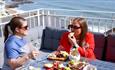 Ladies eating and drinking on balcony with sea views, Champagne & Fromage Tasting at The Wellington, food & drink event, what's on, Isle of Wight