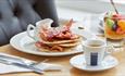 Bacon and pancakes, fruit in a glass and coffee on the table, Luccombe Manor, Shanklin, Isle of Wight, Hotel, seaside location, sea view