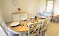 Dining table and chairs inside an apartment at Chale Bay Farm, self catering, apartments, Isle of Wight