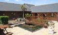 Bridge over pond in the courtyard at Chale Bay Farm, self catering, apartments, Isle of Wight