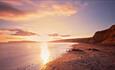 Sunset reflecting on the sea at Compton Beach, Isle of Wight, Things to Do