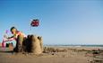 Girl making sandcastle on Compton Beach, Isle of Wight, Things to Do