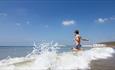 Boy running into the sea at Compton Beach, Isle of Wight, Things to Do