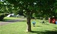 Tents pitched and children's play area at Old Barn Touring Park, Sandown