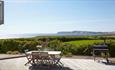 Outside dining area on patio with BBQ and sea view at Flackstead, Classic Cottages, Isle of Wight, self catering, accommodation
