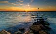 Sunset over the sea at Gurnard Beach, Isle of Wight, Things to Do