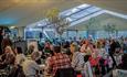 Attendees sitting in the marquee at Isle of Wight Literary Festival, what's on, event