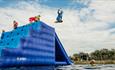 Man jumping off the side at Isle of Wight Aqua Park, Tapnell Farm, watersports, outdoor activities