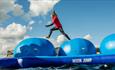 Lady bouncing on Moon Jump at the Isle of Wight Aqua Park, Tapnell Farm, Isle of Wight, Things to Do