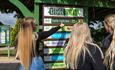 People looking at the Keeper Talks board at Monkey Haven, sanctuary, Isle of Wight, Things to Do - copyright: Jason Swain