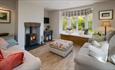 Wood burning fire in living area at Lily Cottage, Wight Escapes, self catering, places to stay, Isle of Wight