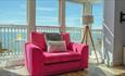 Isle of Wight, Accommodation, Self Catering Agency, Mermaid Holidays, Pink double seat in front of window with panoramic sea views
