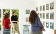 People viewing the art on the wall at Sadie Tierney's Studio in Ventnor at the 2025 Isle of Wight Open Studios, event, what's on - image credit: Julia
