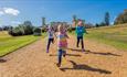 Children running with Osborne House in background, attraction, things to do, East Cowes, Isle of Wight