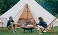 Couple enjoying marshmallows on the fire outside the bell tent, Island Bell Tents, glamping, self catering, Isle of Wight