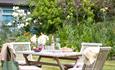 Outside dining table and chairs in garden at Pucks Oak, Wight Locations property, Isle of Wight, self catering, cottages and houses, luxury