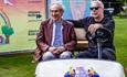 Ray Foulk & John Giddings sitting in a buggy at the Isle of Wight Festival, what's on, event - photo credit: Day Rutherford