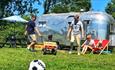 Family enjoying the outside area surrounding the American Airstream at Retro Staycations, unique place to stay, Isle of Wight