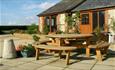 Outside view of Rose Cottage with outdoor picnic table, Atherfield Green Farm Holiday Cottages, Chale, Self Catering