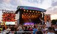 Crowds watching a band on the main stage at the Isle of Wight Festival, music event, what's on