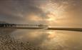 Sunset through the clouds with Sandown Pier in the distance, Sandown beach, Isle of Wight, Things to Do