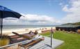 Outside loungers with umbrella facing a sea view at Sea Lights, Classic Cottages, Isle of Wight, self catering, accommodation