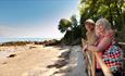 Couple at Seagrove Bay looking out to sea, Isle of Wight, coach trips, Leisuretime by Toureasy