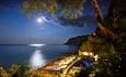 Night time view with a bright moon overlooking the Fisherman's Cottage at Shanklln beach, Things to Do, Isle of Wight