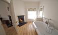 Roll-top bath with open fire at Signal Point, Ventnor Botanic Garden, Self Catering, Isle of Wight