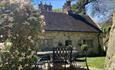 Dining table and chairs within the grounds of a cottage, Island Holiday Homes, self catering, Isle of Wight