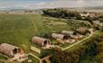 Aerial view of Tapnell Farm with exterior view of modulogs, Tom's Eco Lodge, self-catering, West Wight, Isle of Wight