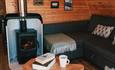 Living area with wood burner in a Modulog at Tom's Eco Lodge, Tapnell Farm Holiday Destination, self-catering, West Wight, Isle of Wight